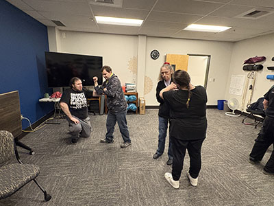 pairs of students practicing self defense techniques